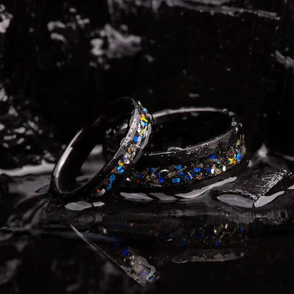 Matching wedding bands made of black hammered tungsten with galaxy opal and meteorite