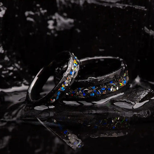Matching wedding bands made of black hammered tungsten with galaxy opal and meteorite