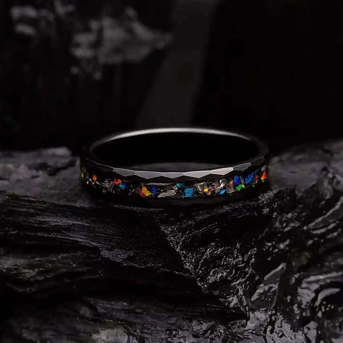 4mm black hammered tungsten ring with blue opal and meteorite. Ring is laying on a coal